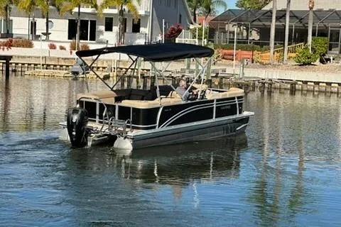 Slide: The Image of 2017 Harris Cruiser 220 pontoon boat on a calm residential waterway. - 11