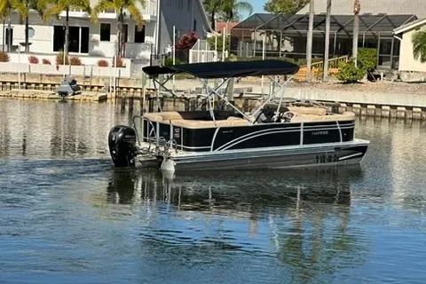 Slide: The Image of 2017 Harris Cruiser 220 pontoon boat on a calm residential waterway. - 12