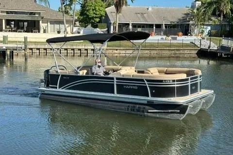 Slide: The Image of 2017 Harris Cruiser 220 pontoon boat on a calm residential waterway. - 15