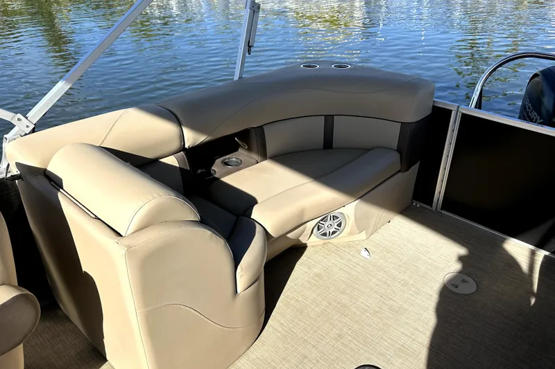 Slide: The Image of 2017 Harris Cruiser 220 pontoon boat interior with beige seating and water view. - 20