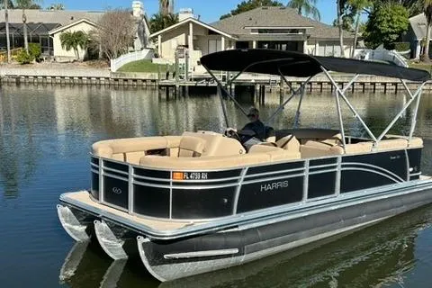 Slide: The Image of 2017 Harris Cruiser 220 pontoon boat on a calm residential waterway. - 3