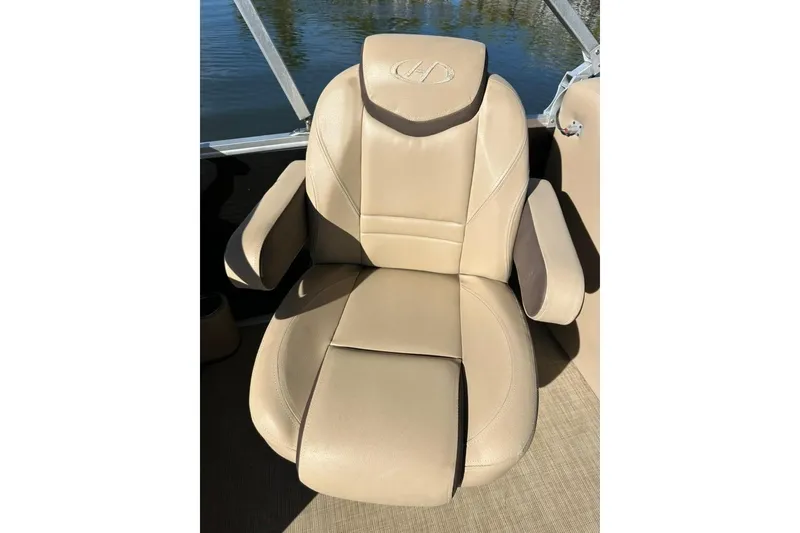 Slide: The Image of Beige captain's chair on 2017 Harris Cruiser 220 boat, with armrests and headrest. - 33