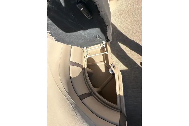 Slide: The Image of 2017 Harris Cruiser 220 boat seat storage compartment open, revealing interior space. - 39