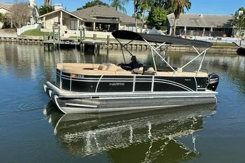 Slide: The Image of 2017 Harris Cruiser 220 pontoon boat on calm water near residential area. - 4