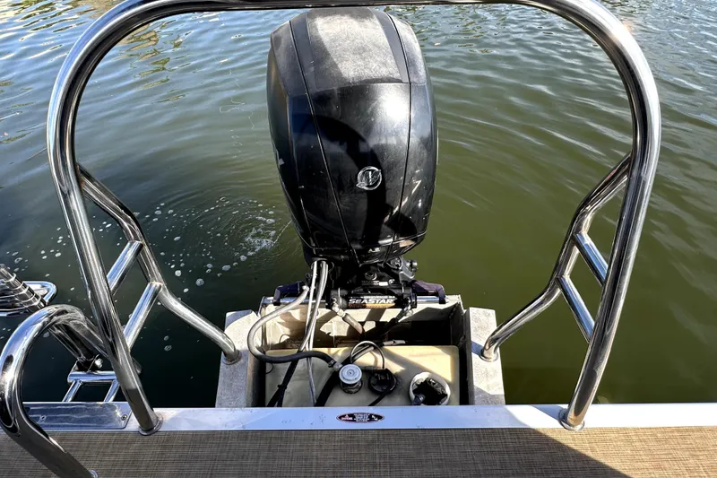 Slide: The Image of 2017 Harris Cruiser 220 boat engine with railing, on calm water. - 42