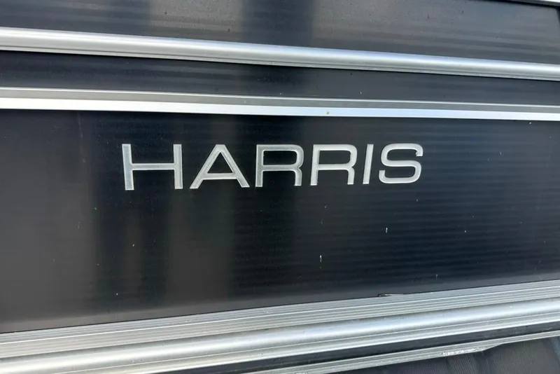 Slide: The Image of 2017 Harris Cruiser 220 boat logo on black panel. - 49