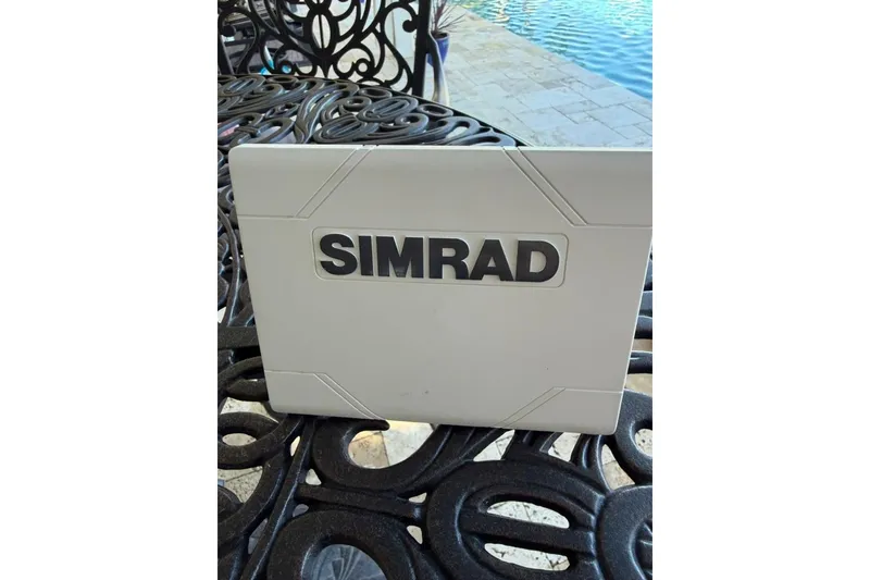 Slide: The Image of Simrad device on ornate table near pool, Harris Cruiser 220, 2017 model. - 51