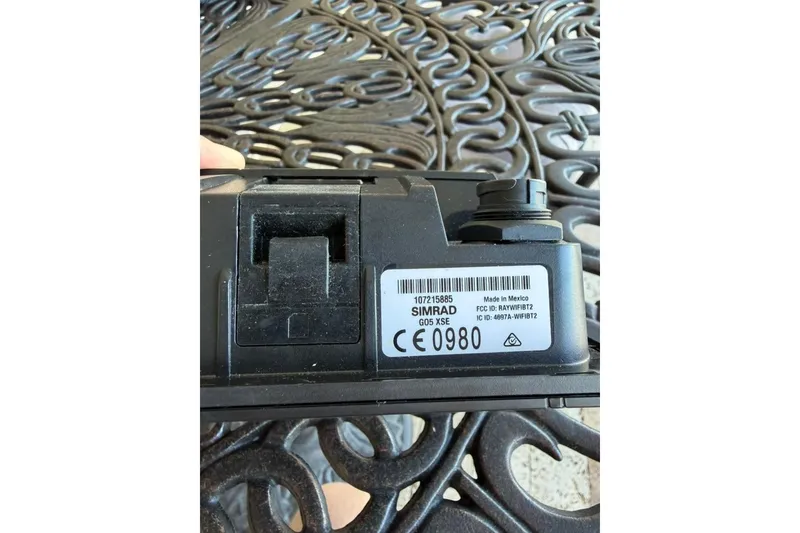 Slide: The Image of Close-up of Simrad GO5 XSE device on ornate metal surface. - 53