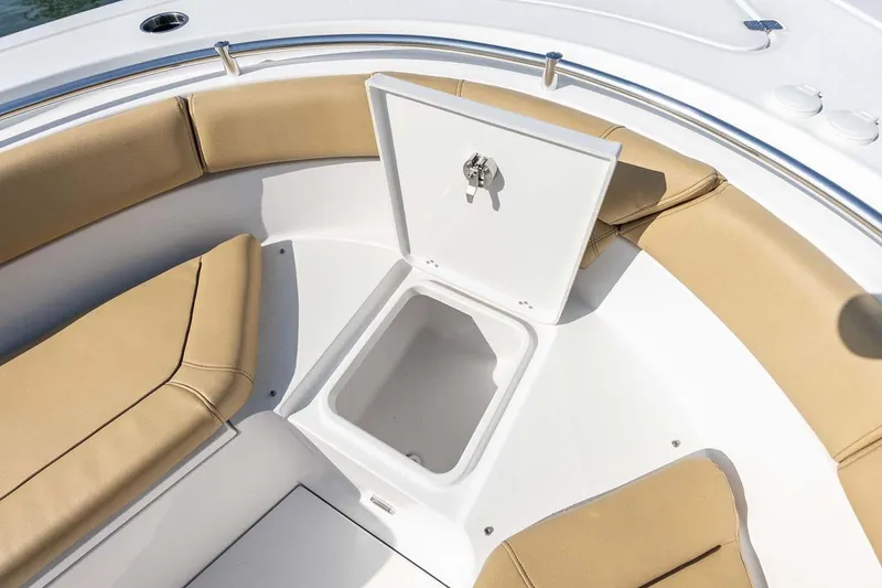 Slide: The Image of Manufacturer Provided Image: 2025 Sportsman Heritage 261 Center Console boat with open storage compartment and tan seating. - 9