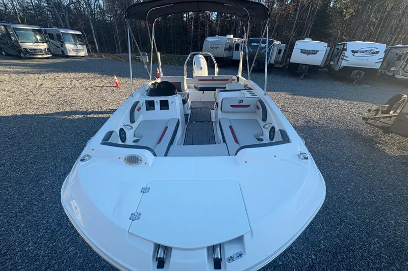 Slide: The Image of 2023 Hurricane SunDeck Sport 205 OB boat with seating, parked on gravel lot. - 10