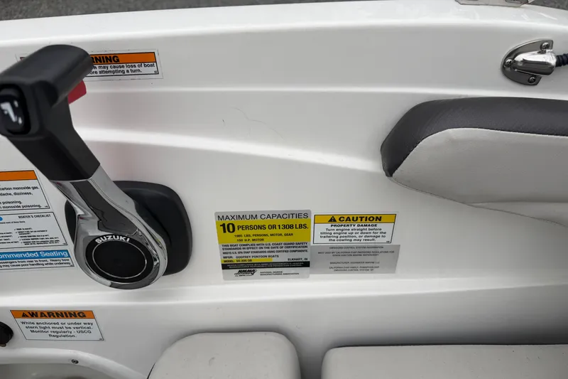 Slide: The Image of 2023 Hurricane SunDeck Sport 205 OB boat controls with capacity and caution labels. - 13