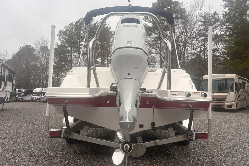 Slide: The Image of 2023 Hurricane SunDeck Sport 205 OB boat on trailer, rear view, in outdoor setting. - 17