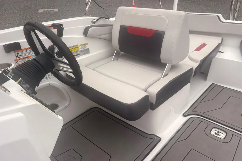 Slide: The Image of 2023 Hurricane SunDeck Sport 205 OB boat interior with steering wheel and seating. - 25