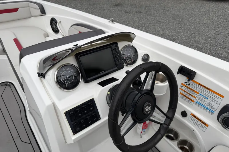 Slide: The Image of 2023 Hurricane SunDeck Sport 205 OB boat dashboard with steering wheel and controls. - 30