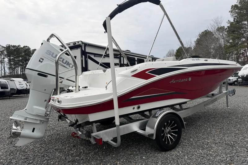 Slide: The Image of 2023 Hurricane SunDeck Sport 205 OB boat with Suzuki outboard motor on trailer. - 44