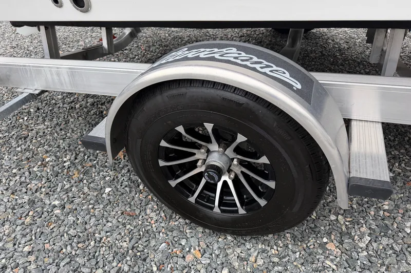 Slide: The Image of Trailer wheel of 2023 Hurricane SunDeck Sport 205 OB on gravel surface. - 5