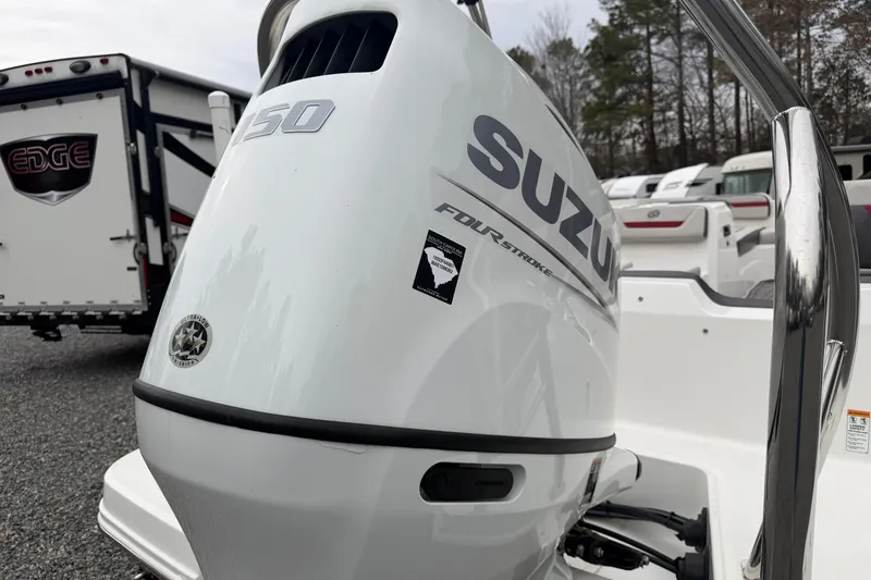 Slide: The Image of 2023 Hurricane SunDeck Sport 205 OB with Suzuki outboard motor in a parking lot. - 6