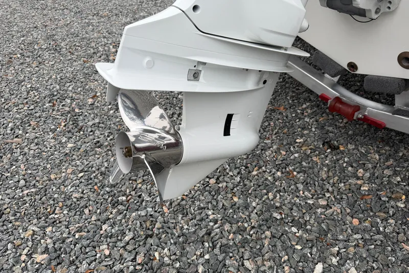 Slide: The Image of 2023 Hurricane SunDeck Sport 205 OB outboard motor on gravel surface. - 7