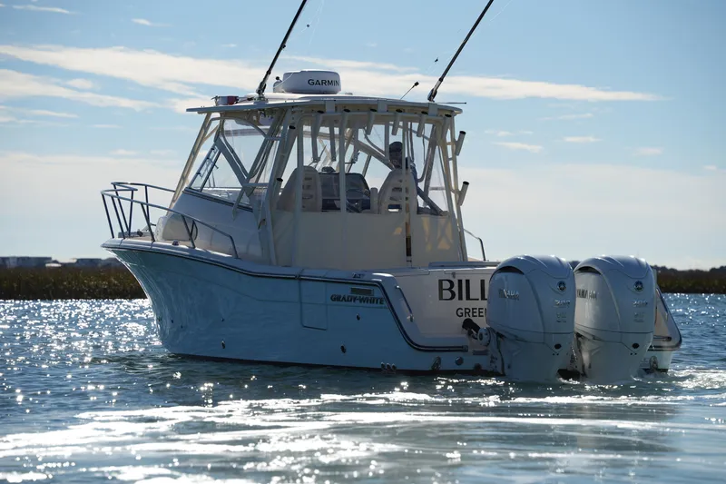 Slide: The Image of 2023 Grady-White Marlin 300 boat on water with dual Yamaha engines. - 1