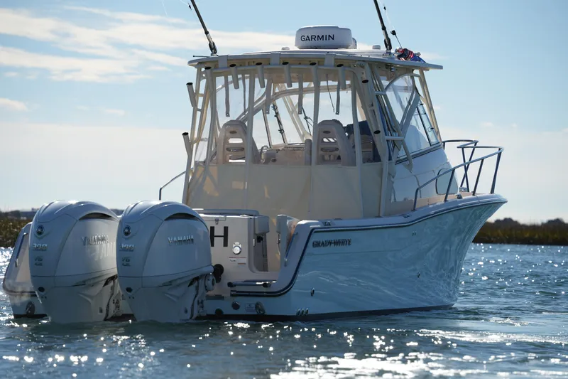 Slide: The Image of 2023 Grady-White Marlin 300 boat with twin Yamaha engines on water. - 10