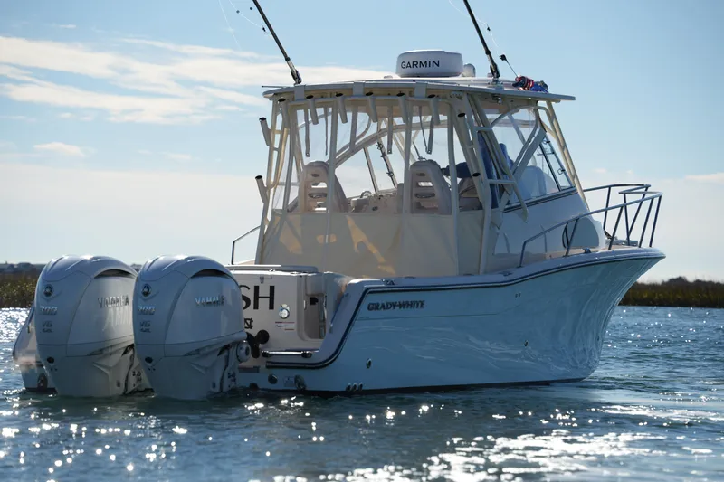 Slide: The Image of 2023 Grady-White Marlin 300 boat with twin Yamaha engines on water. - 11
