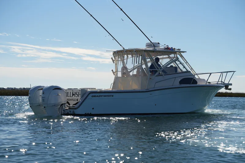 Slide: The Image of 2023 Grady-White Marlin 300 boat cruising on a sunny day. - 14