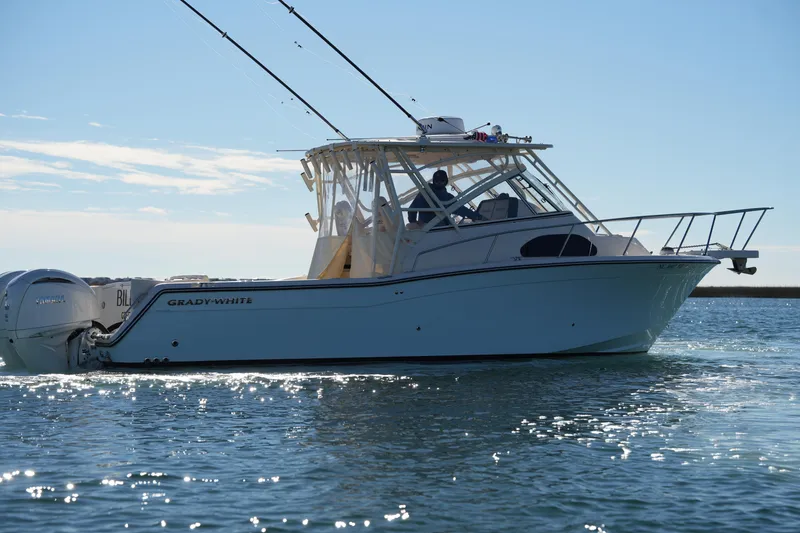 Slide: The Image of 2023 Grady-White Marlin 300 boat cruising on a sunny day. - 16