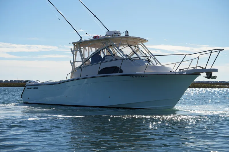 Slide: The Image of 2023 Grady-White Marlin 300 boat cruising on a sunny day. - 17