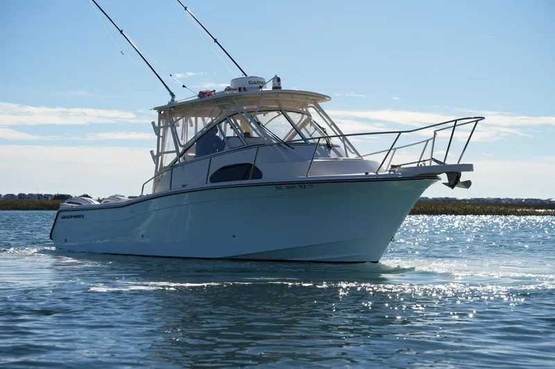 Slide: The Image of 2023 Grady-White Marlin 300 boat cruising on a sunny day. - 18