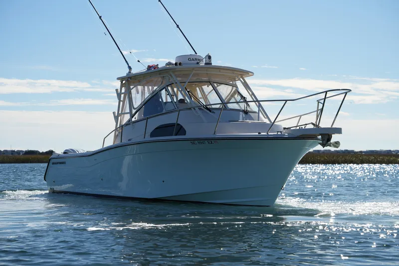 Slide: The Image of 2023 Grady-White Marlin 300 boat cruising on a sunny day. - 19