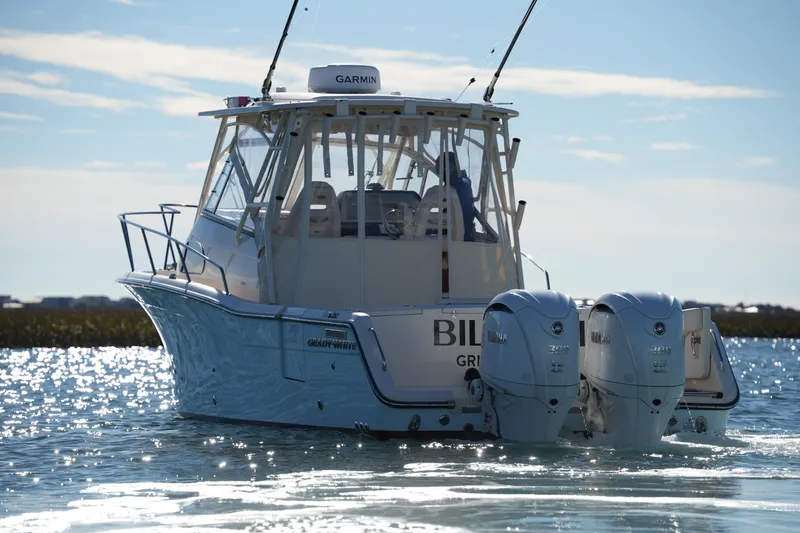 Slide: The Image of 2023 Grady-White Marlin 300 boat with dual engines on water. - 2