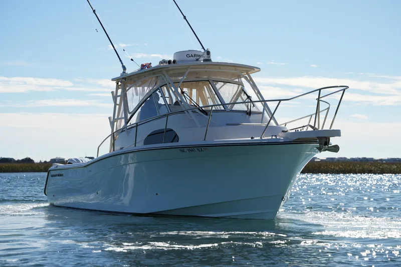 Slide: The Image of 2023 Grady-White Marlin 300 boat cruising on a sunny day. - 20