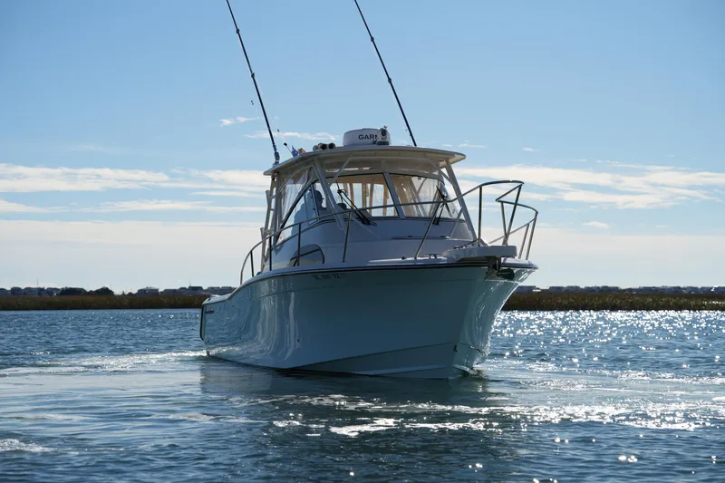 Slide: The Image of 2023 Grady-White Marlin 300 boat cruising on a sunny day. - 21