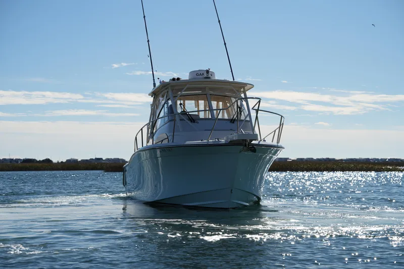 Slide: The Image of 2023 Grady-White Marlin 300 boat on sparkling water under clear sky. - 22