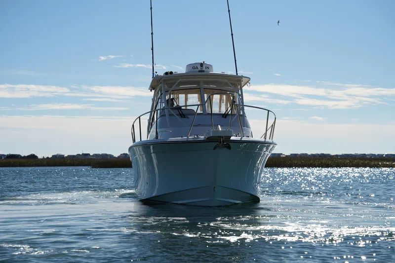 Slide: The Image of 2023 Grady-White Marlin 300 boat on sparkling water under clear sky. - 23