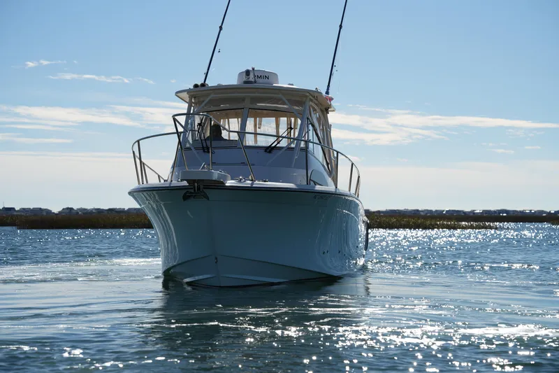 Slide: The Image of 2023 Grady-White Marlin 300 boat on sparkling water under clear sky. - 26