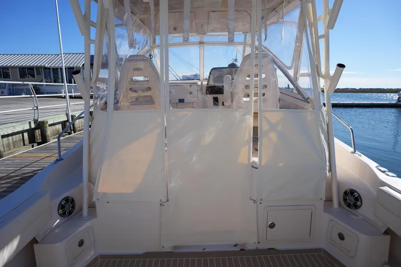Slide: The Image of 2023 Grady-White Marlin 300 boat interior with clear enclosure, dockside view. - 27