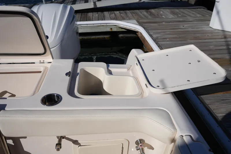 Slide: The Image of 2023 Grady-White Marlin 300 boat deck with open storage compartment. - 30
