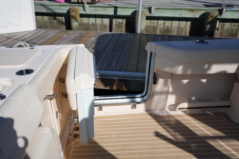 Slide: The Image of 2023 Grady-White Marlin 300 boat interior with open transom door, dockside view. - 33