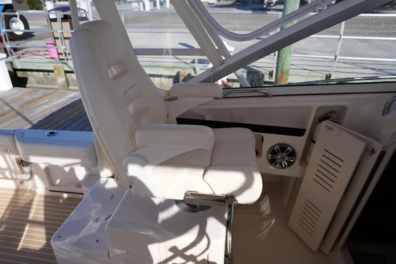 Slide: The Image of Captain's chair on 2023 Grady-White Marlin 300 boat, featuring luxurious white upholstery. - 39