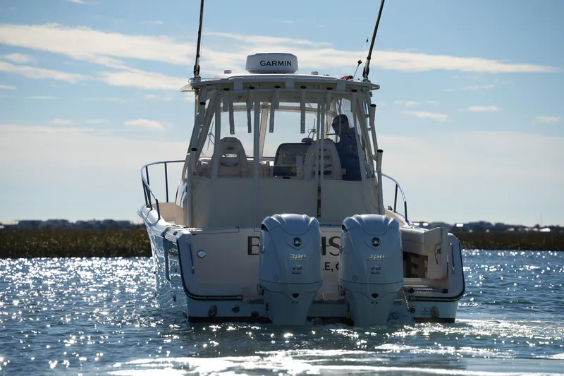 Slide: The Image of 2023 Grady-White Marlin 300 boat on water, rear view with dual engines. - 4