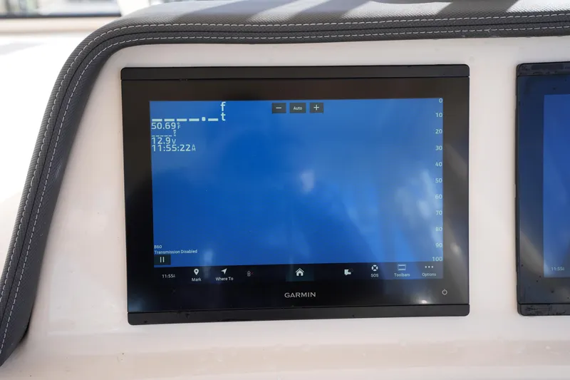 Slide: The Image of Garmin display on 2023 Grady-White Marlin 300 boat dashboard, showing navigation data. - 43