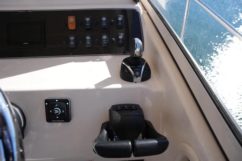 Slide: The Image of Control panel of 2023 Grady-White Marlin 300 boat with joystick and switches. - 45