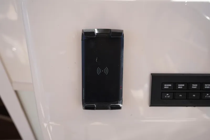 Slide: The Image of Control panel and wireless charging pad on 2023 Grady-White Marlin 300 boat. - 48