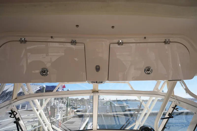 Slide: The Image of 2023 Grady-White Marlin 300 boat interior with overhead storage compartments. - 49