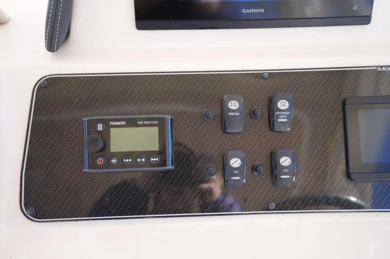 Slide: The Image of Control panel of 2023 Grady-White Marlin 300 boat with Fusion MS-NRX300 and switches. - 50