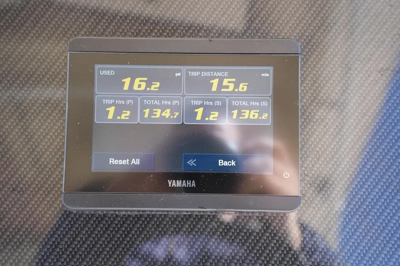 Slide: The Image of Yamaha display showing fuel usage and trip data on 2023 Grady-White Marlin 300 boat. - 54