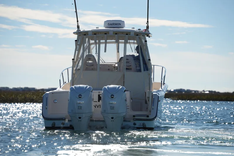 Slide: The Image of 2023 Grady-White Marlin 300 boat with dual Yamaha engines on sparkling water. - 6