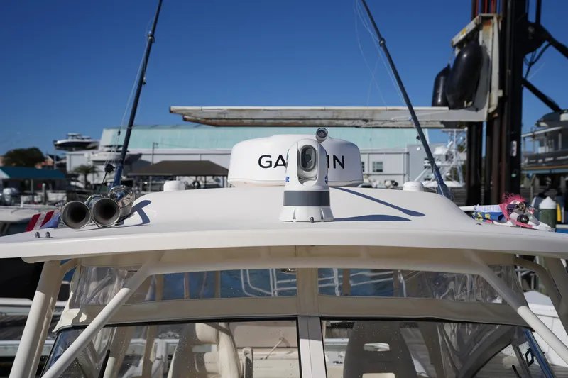 Slide: The Image of 2023 Grady-White Marlin 300 boat with radar and antennas at a marina. - 64