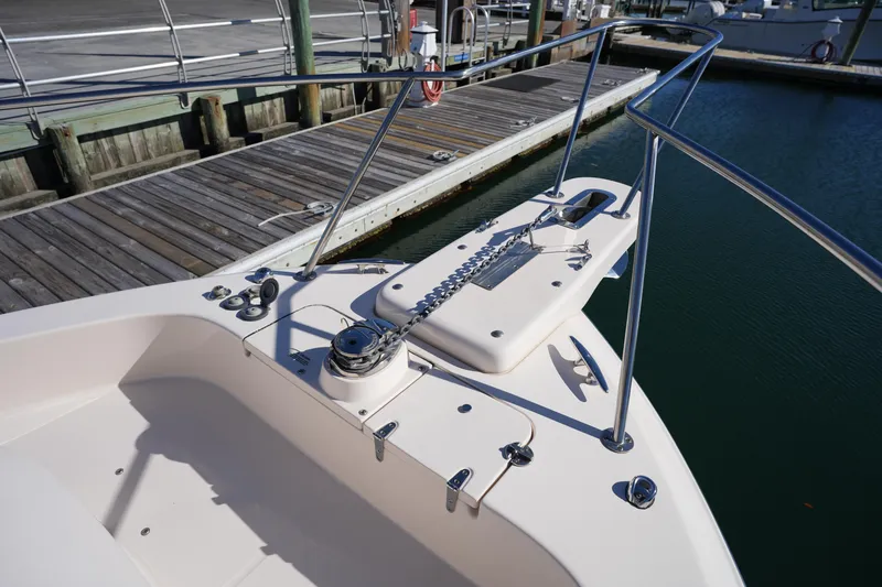Slide: The Image of 2023 Grady-White Marlin 300 boat docked, showcasing bow and anchor system. - 65